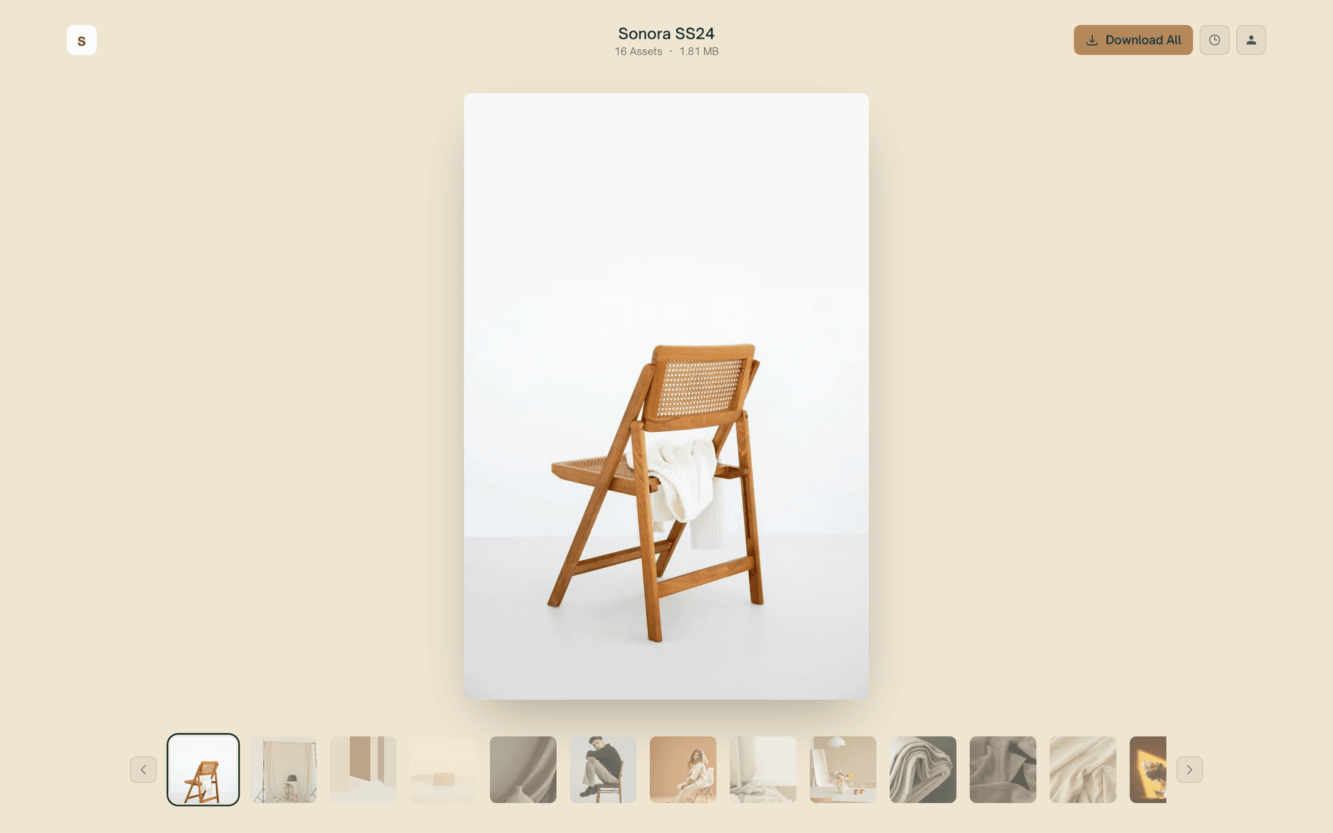 A warm cream Reel page presenting one photo at a time above a thumbnail strip